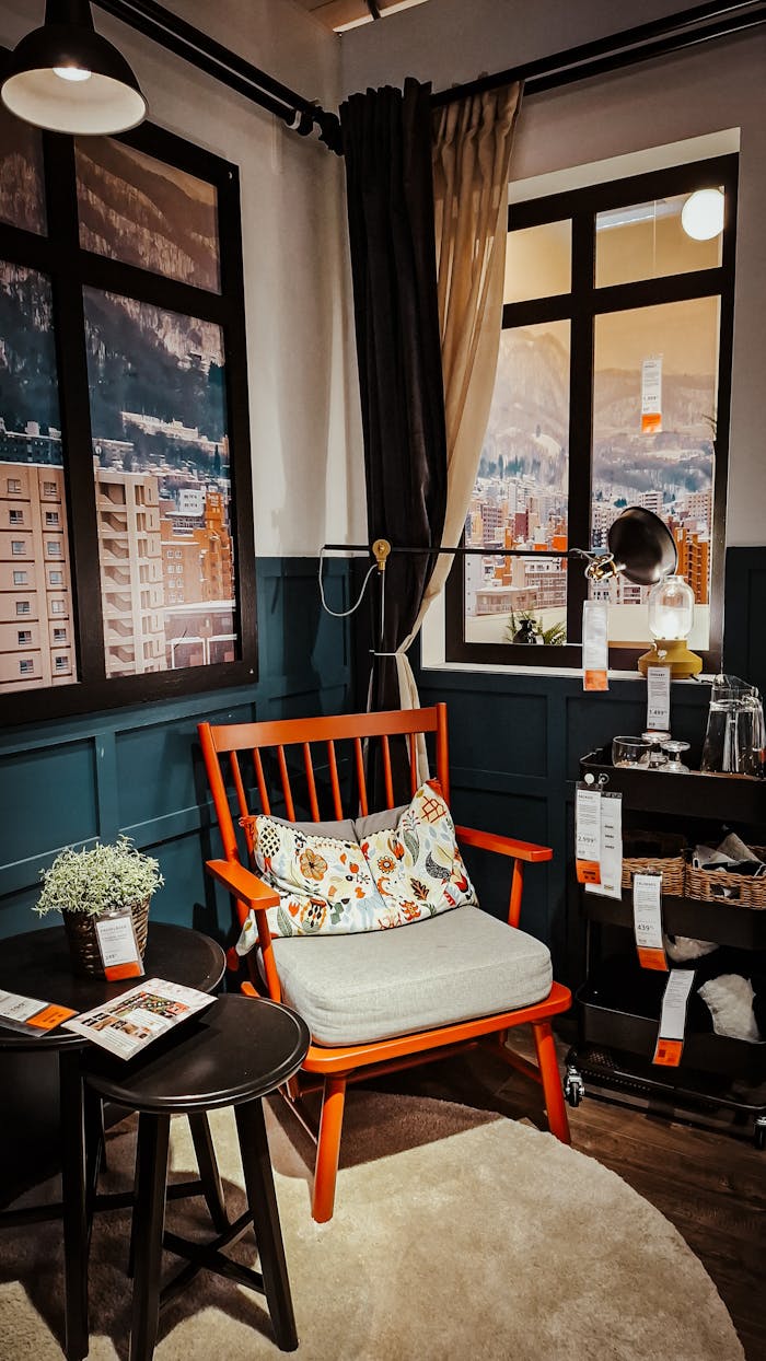 gallery-03 Stylish living room setup with chair, table, and mountain view.